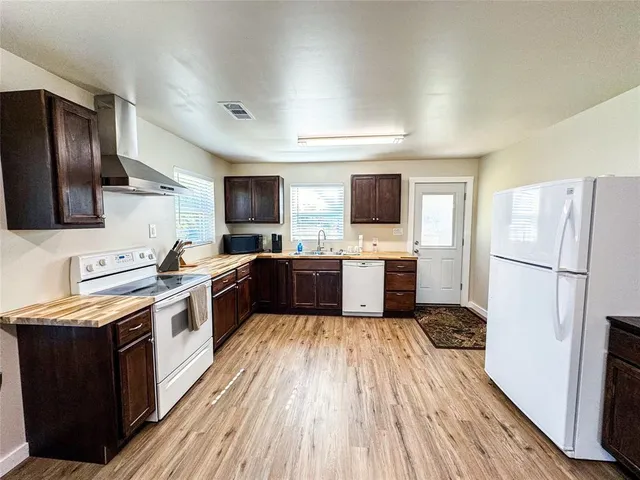 a kitchen with stainless steel appliances a refrigerator stove microwave and sink