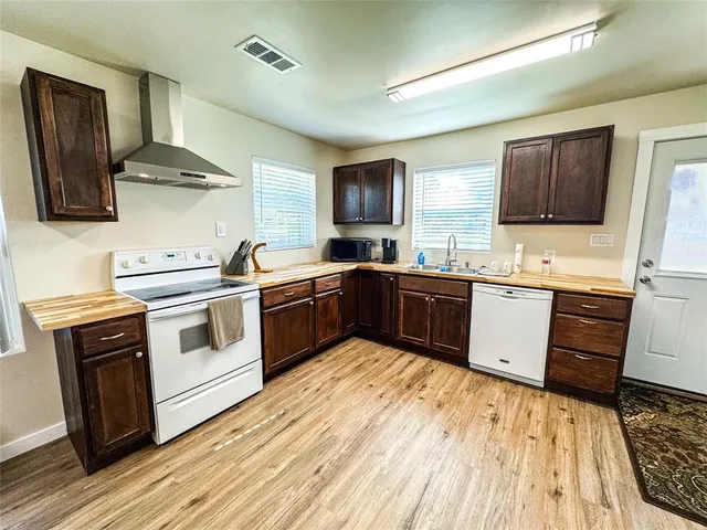 a kitchen with a sink cabinets and stainless steel appliances