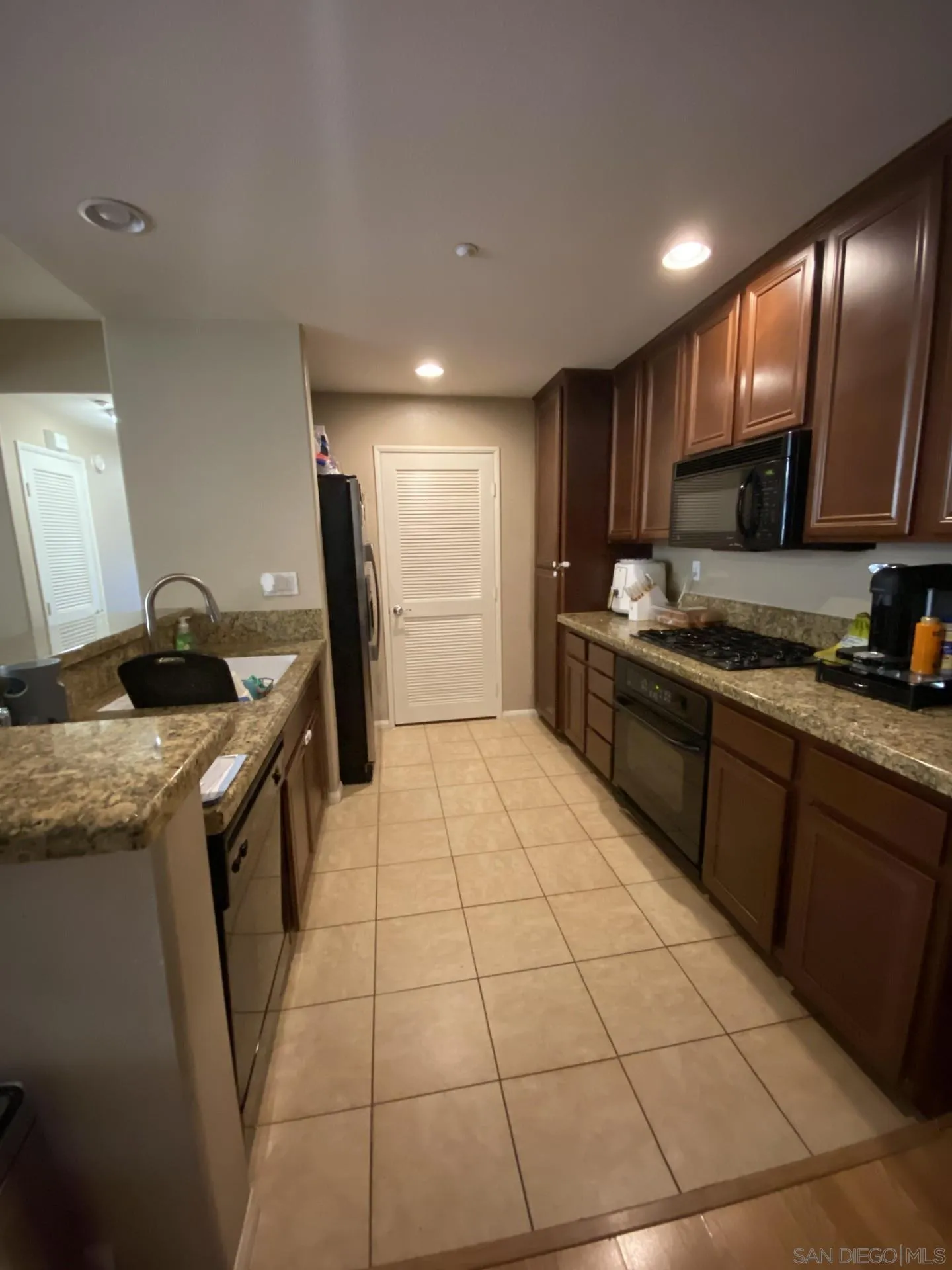 64 Via Sovana Santee, CA 92071 - Photo 5 of 15 a kitchen with stainless steel appliances granite countertop a sink stove and cabinets