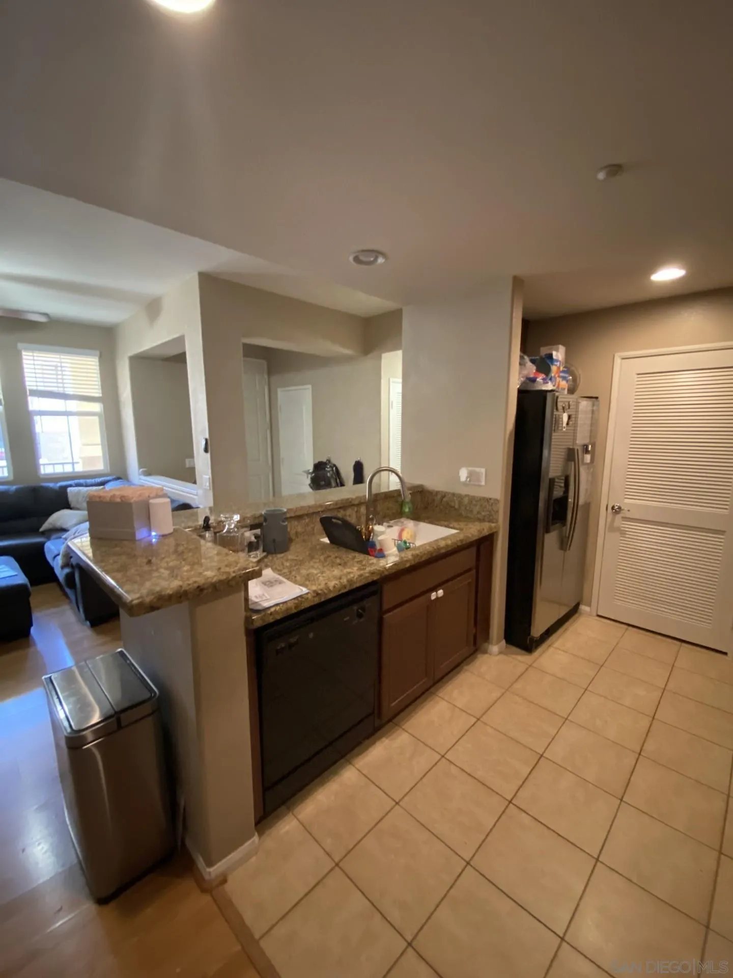 64 Via Sovana Santee, CA 92071 - Photo 6 of 15 a large kitchen with kitchen island granite countertop a refrigerator a sink and a stove