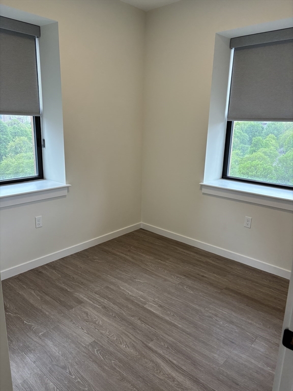 47 Winter Street, Unit 601 Boston, MA 02108 - Photo 9 of 12 an empty room with wooden floor and a window