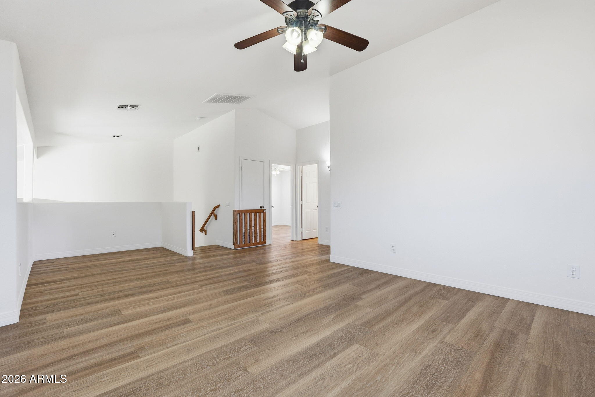742 North Boulder Street Gilbert, AZ 85234 - Photo 12 of 22 a view of an empty room with window and wooden floor