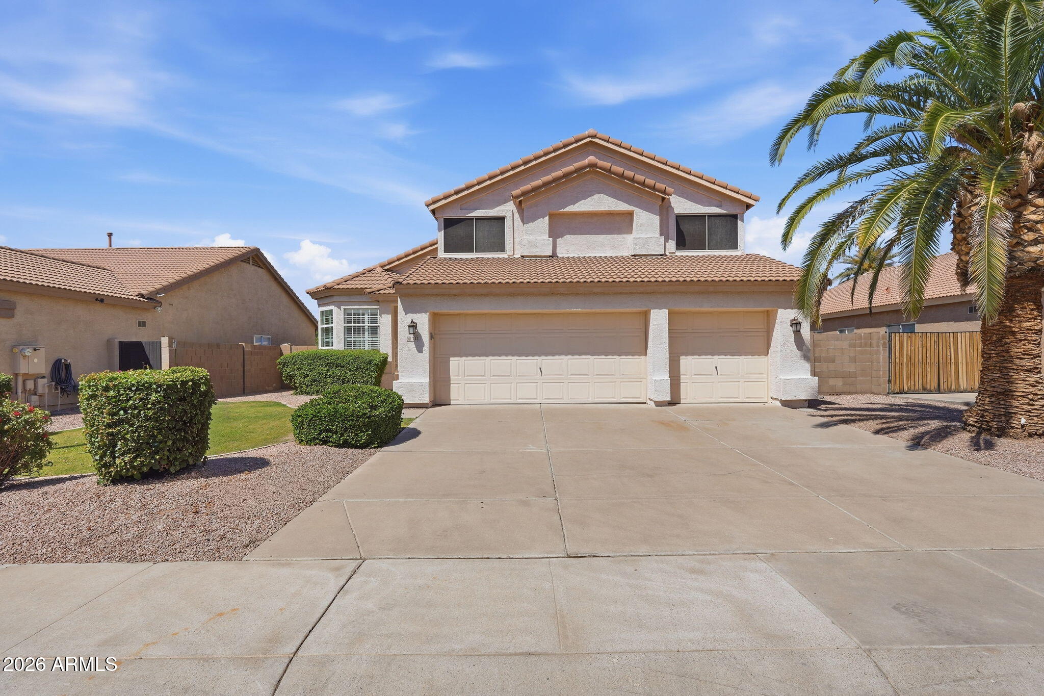 742 North Boulder Street Gilbert, AZ 85234 - Photo 3 of 22 a front view of a house with a yard and garage