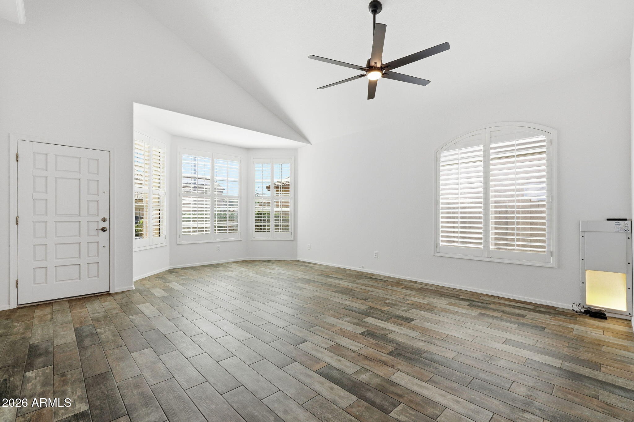742 North Boulder Street Gilbert, AZ 85234 - Photo 6 of 22 a view of an empty room with a window and wooden floor