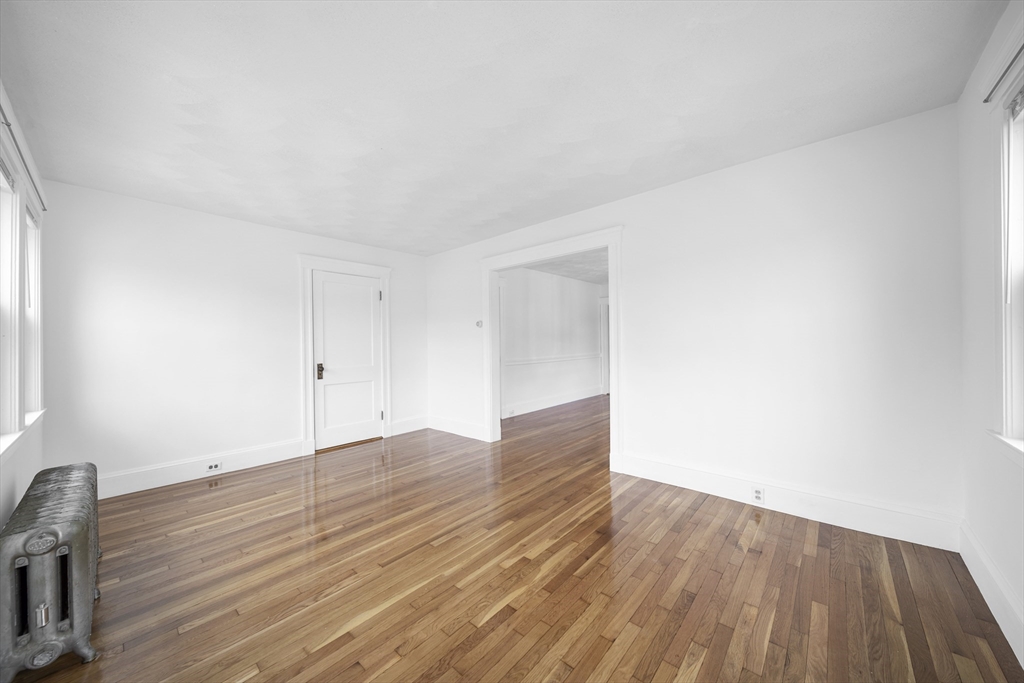 180 Faneuil Street, Unit 2 Boston, MA 02135 - Photo 11 of 37 a view of an empty room and wooden floor