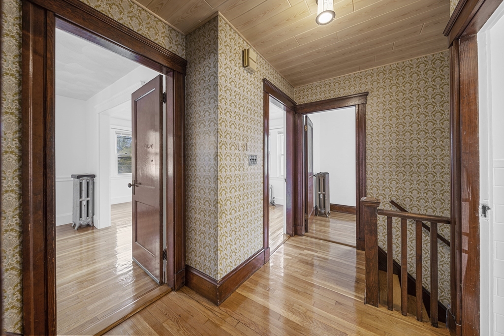 180 Faneuil Street, Unit 2 Boston, MA 02135 - Photo 13 of 37 a view of a hallway with wooden floor and staircase