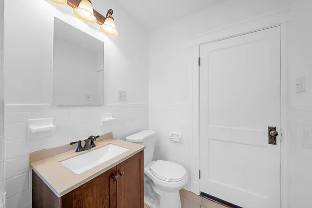 a bathroom with a sink a toilet and mirror