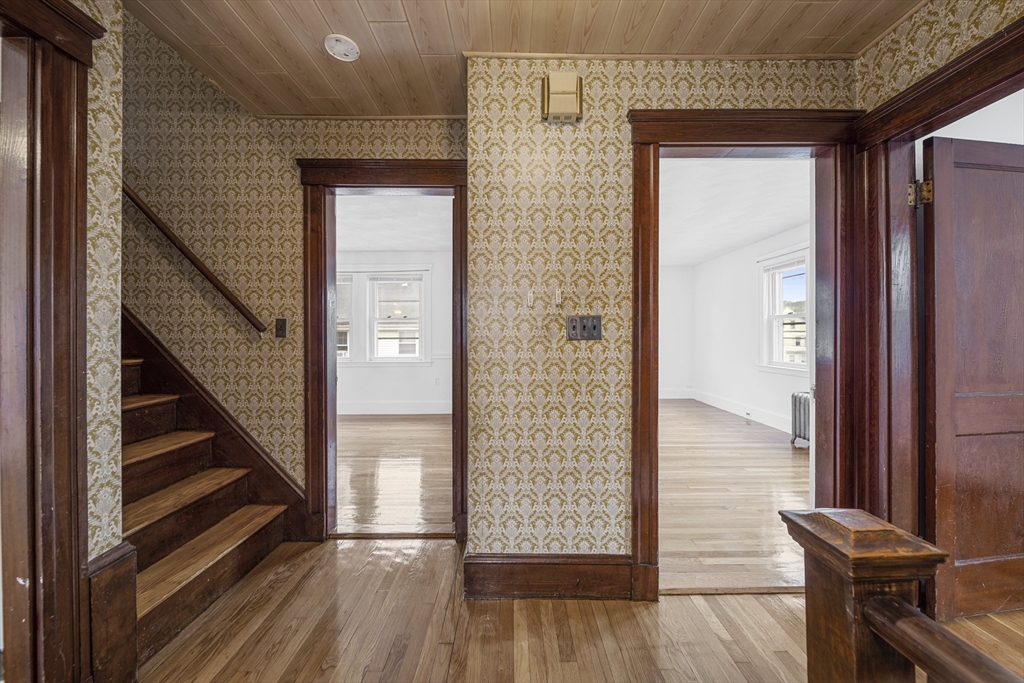 180 Faneuil Street, Unit 2 Boston, MA 02135 - Photo 18 of 37 a view of a hallway with wooden floor and staircase