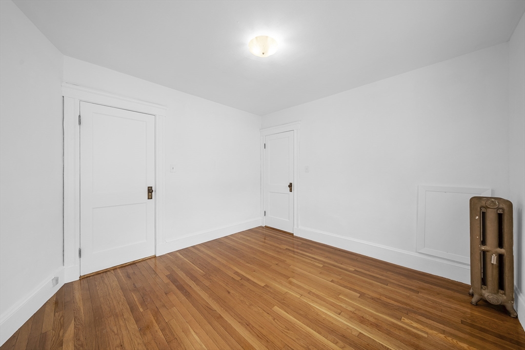 180 Faneuil Street, Unit 2 Boston, MA 02135 - Photo 20 of 37 a view of empty room with wooden floor