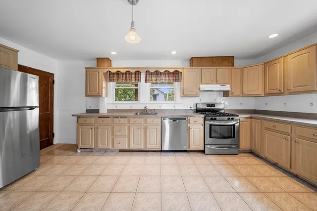 a kitchen with a stove sink and refrigerator