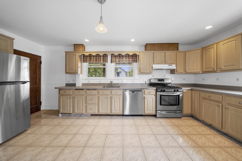 180 Faneuil Street, Unit 2 Boston, MA 02135 - Photo 2 of 37 a kitchen with a stove sink and refrigerator