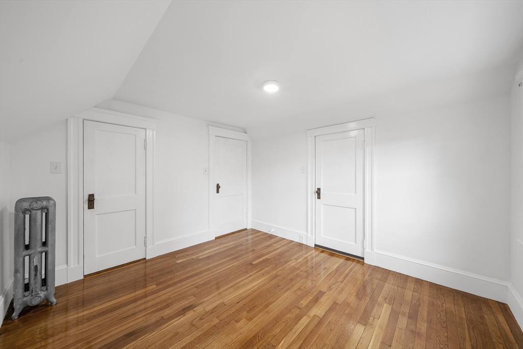 180 Faneuil Street, Unit 2 Boston, MA 02135 - Photo 27 of 37 a view of empty room with wooden floor