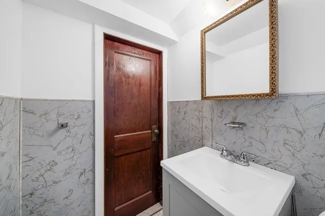 a bathroom with a sink a mirror and vanity