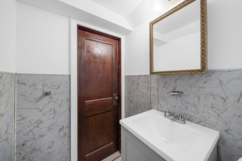 180 Faneuil Street, Unit 2 Boston, MA 02135 - Photo 29 of 37 a bathroom with a sink a mirror and vanity