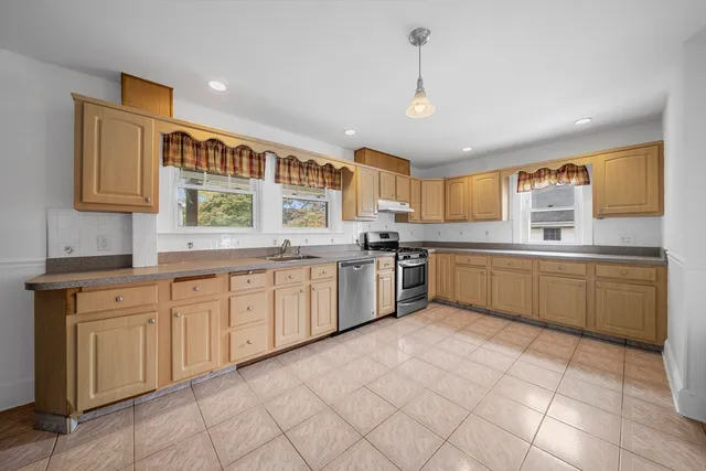 a kitchen with a sink window and cabinets
