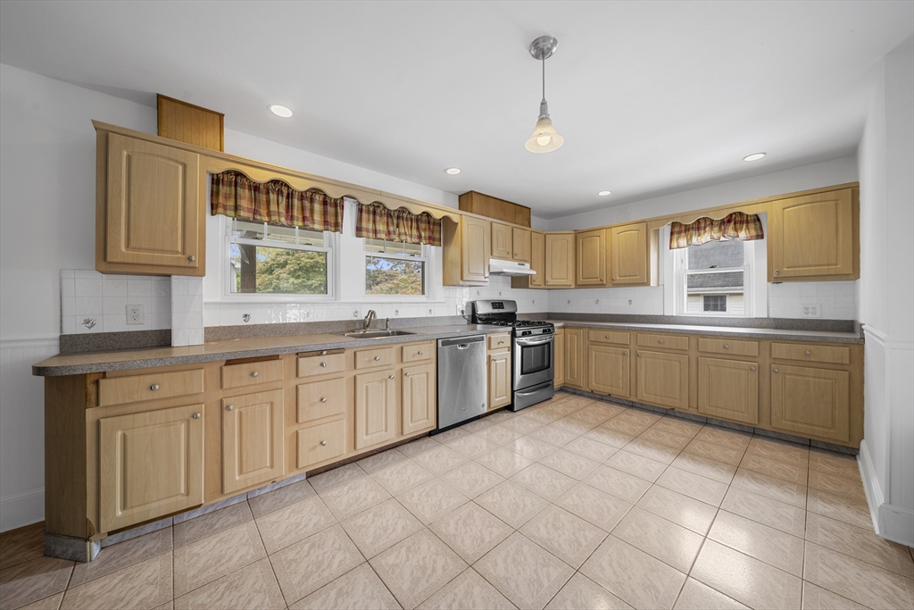 180 Faneuil Street, Unit 2 Boston, MA 02135 - Photo 3 of 37 a kitchen with a sink window and cabinets