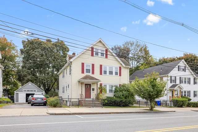 a view of a house with a yard and plants