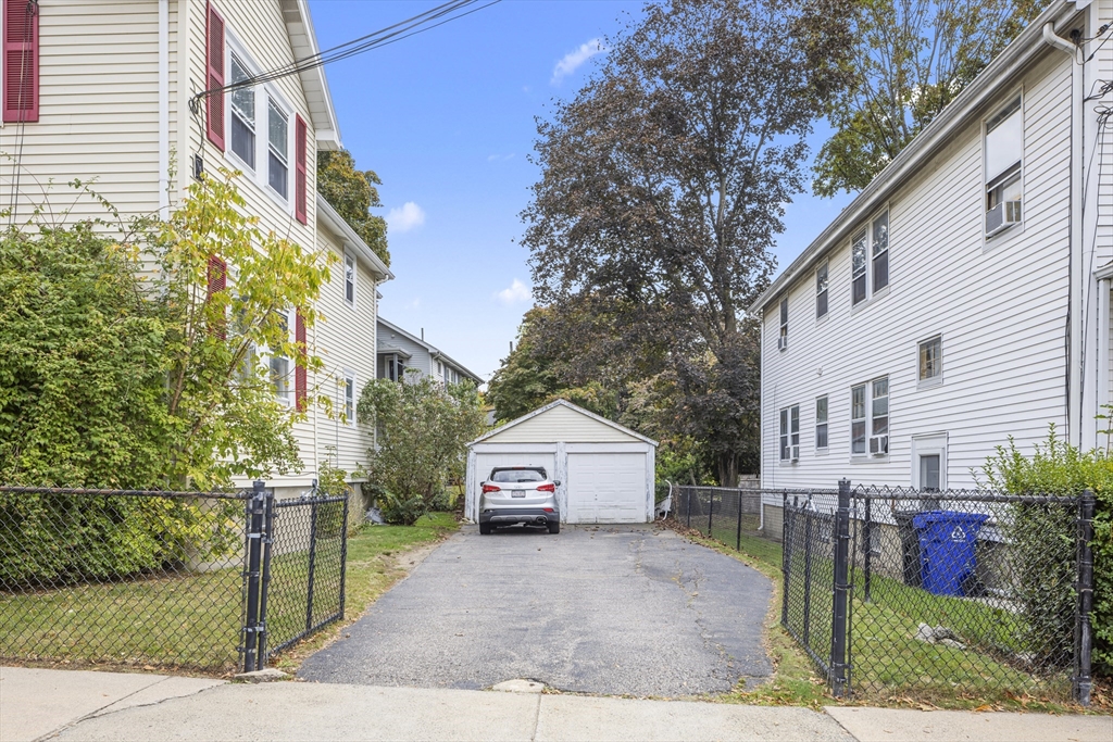 180 Faneuil Street, Unit 2 Boston, MA 02135 - Photo 36 of 37 a view of a house with a yard and plants
