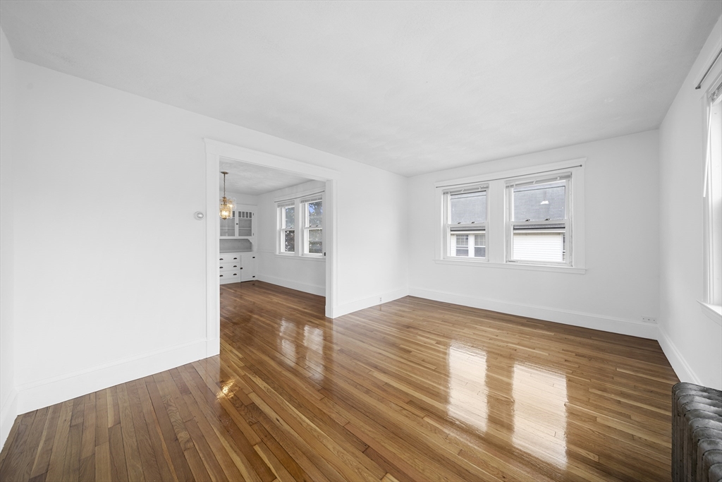 180 Faneuil Street, Unit 2 Boston, MA 02135 - Photo 10 of 37 a view of empty room with wooden floor and fan