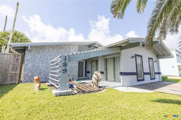 a view of a house with swimming pool and sitting area