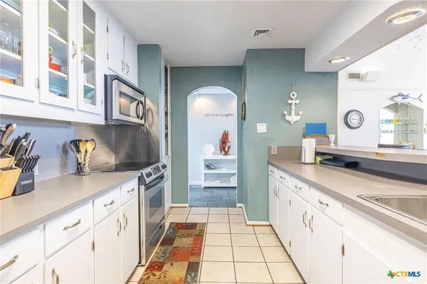 a kitchen with stainless steel appliances granite countertop a sink and cabinets