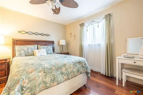 a bedroom with a bed and a large window