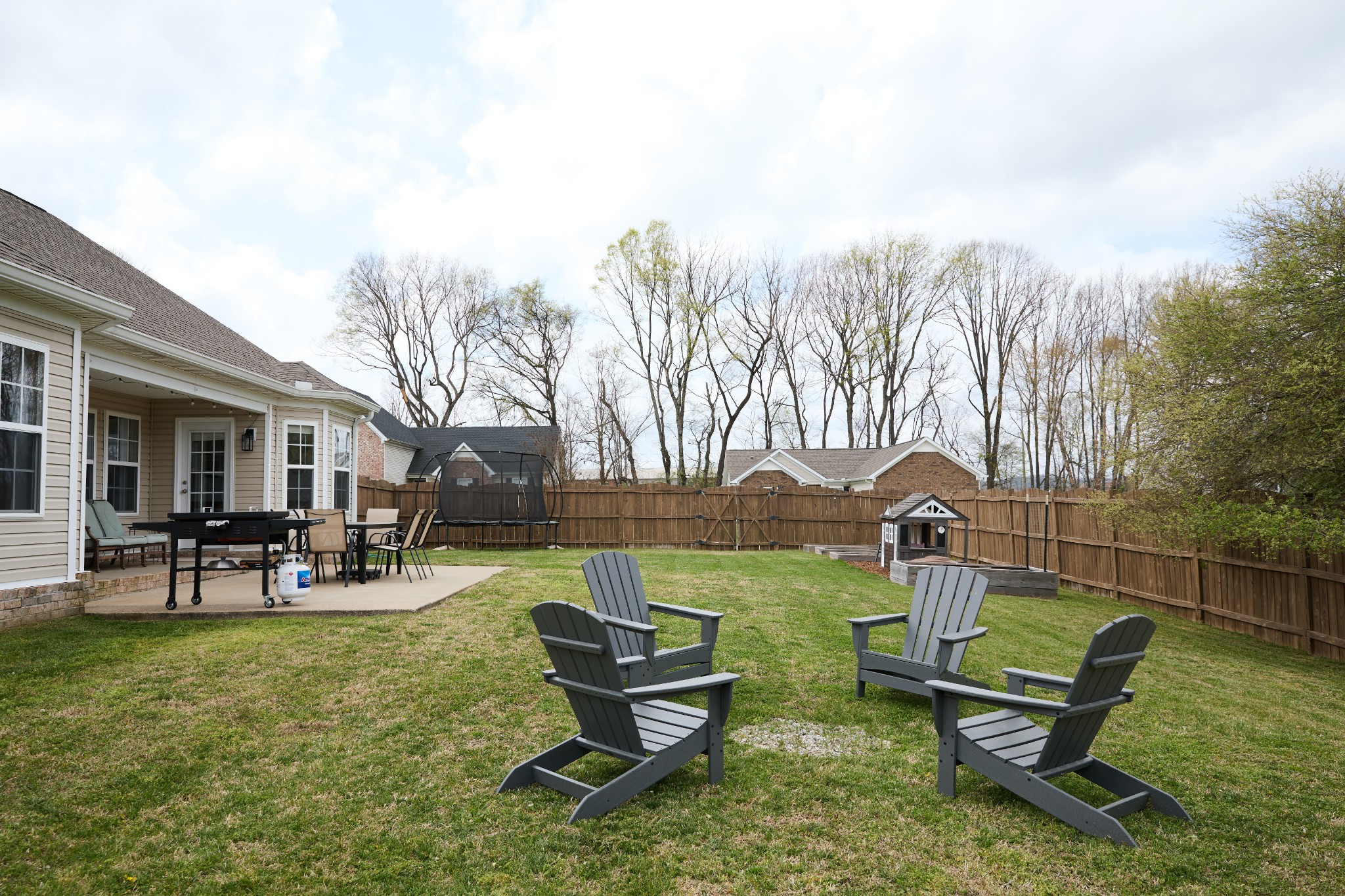 1910 Portview Drive Spring Hill, TN 37174 - Photo 41 of 50 a view of a backyard with table and chairs and wooden fence