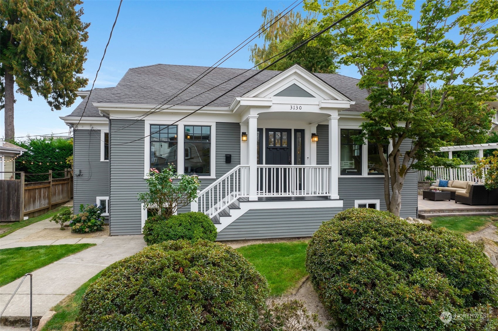 a view of a house with a small yard and potted plants