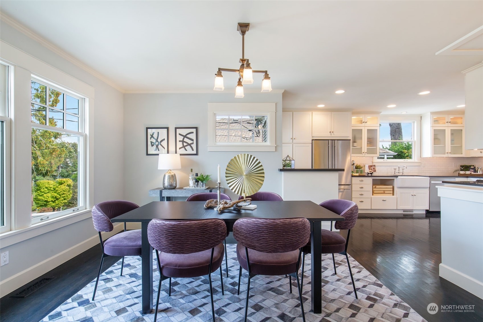 3130 Broadway East Seattle, WA 98102 - Photo 12 of 32 a living room with kitchen couches dining table and chairs with wooden floor