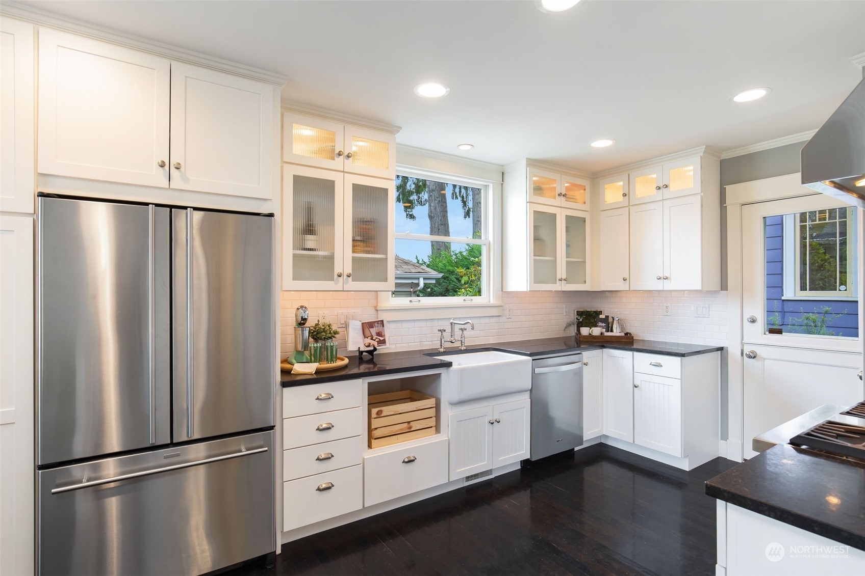 3130 Broadway East Seattle, WA 98102 - Photo 14 of 32 a kitchen with stainless steel appliances a refrigerator sink and cabinets