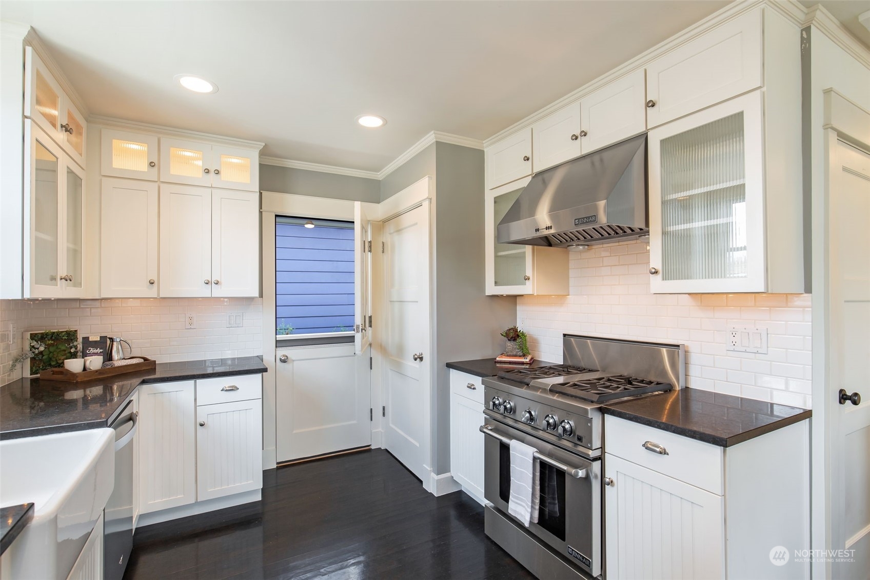 3130 Broadway East Seattle, WA 98102 - Photo 15 of 32 a kitchen with a sink stove top oven and cabinets