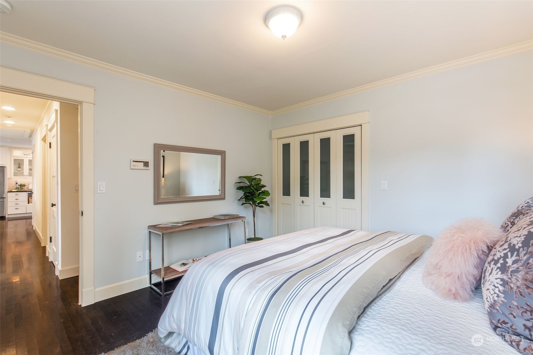 3130 Broadway East Seattle, WA 98102 - Photo 21 of 32 a bedroom with a bed and a potted plant