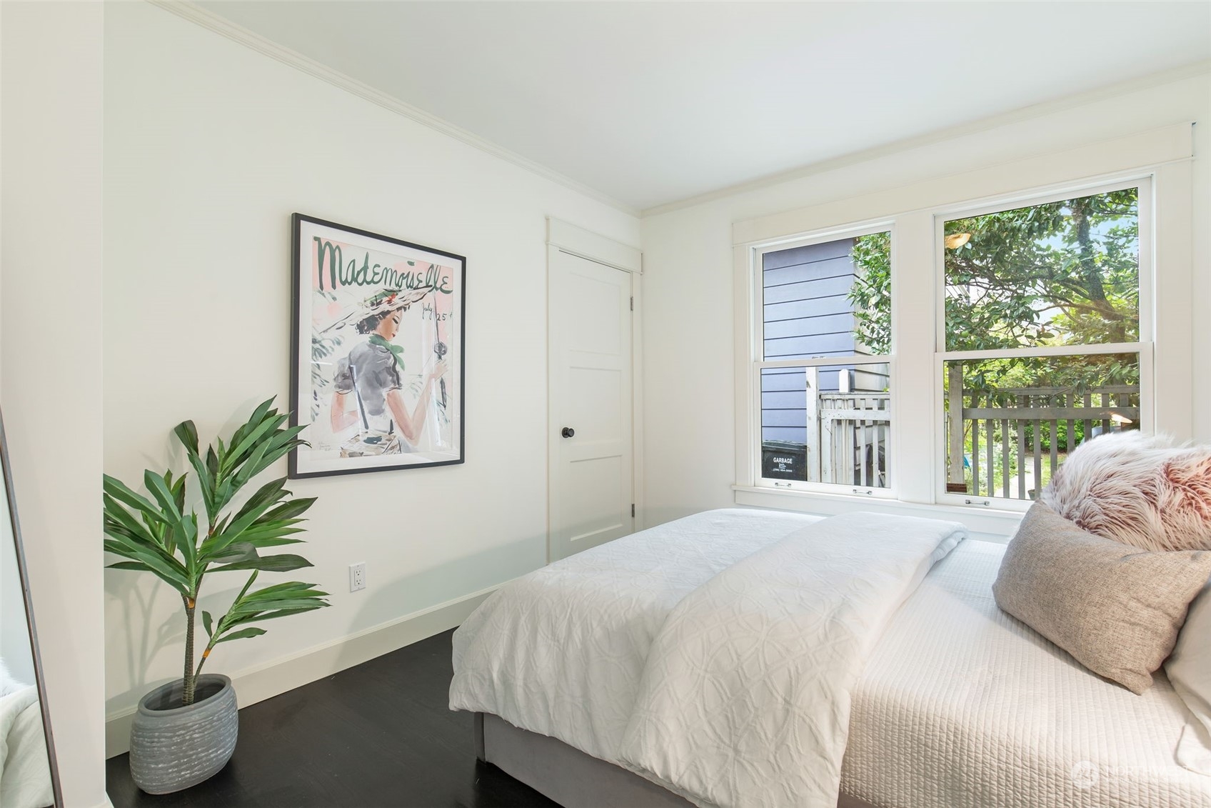 3130 Broadway East Seattle, WA 98102 - Photo 24 of 32 a bedroom with a large bed and a potted plant