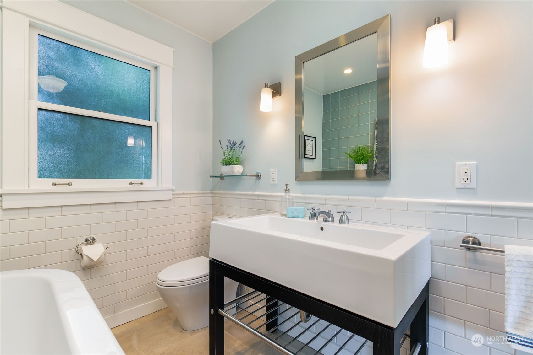 3130 Broadway East Seattle, WA 98102 - Photo 27 of 32 a bathroom with a sink a toilet and mirror