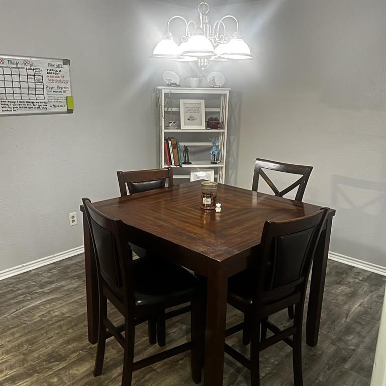2029 Springwood Place, Unit A Carrollton, TX 75006 - Photo 4 of 9 a view of a dining room with furniture a chandelier and wooden floor