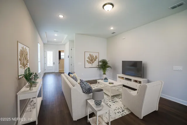 a large kitchen with white cabinets and stainless steel appliances