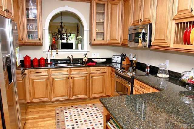 2011 Landings Way Raleigh, NC 27615 - Photo 5 of 10 a kitchen with stainless steel appliances granite countertop a sink dishwasher stove and cabinets with wooden floor