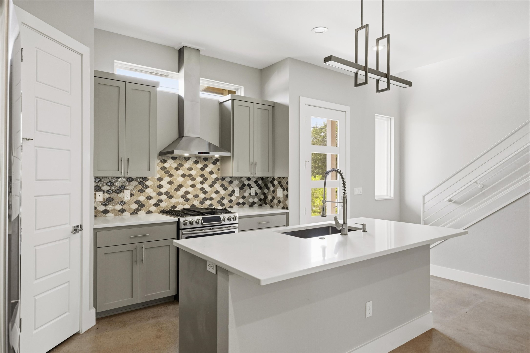1210 Stobaugh Street, Unit B Austin, TX 78757 - Photo 29 of 40 A well-appointed kitchen showcasing contemporary design and convenient island seating.