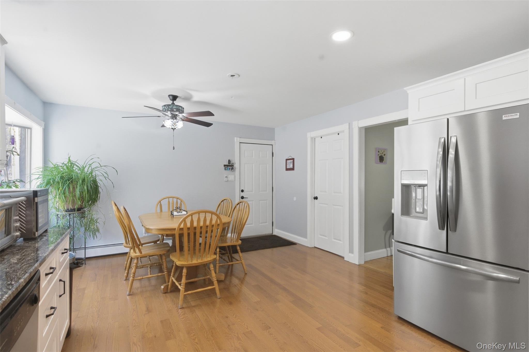 1285 Lakes Road Monroe, NY 10950 - Photo 7 of 45 a dining room with furniture a chandelier and wooden floor