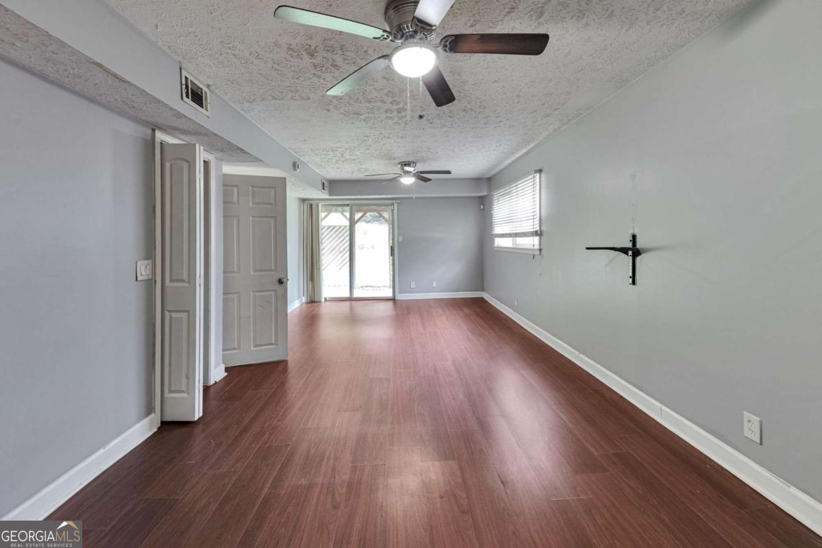 115 Elizabeth Way Ellenwood, GA 30294 - Photo 14 of 15 wooden floor in an empty room with a window