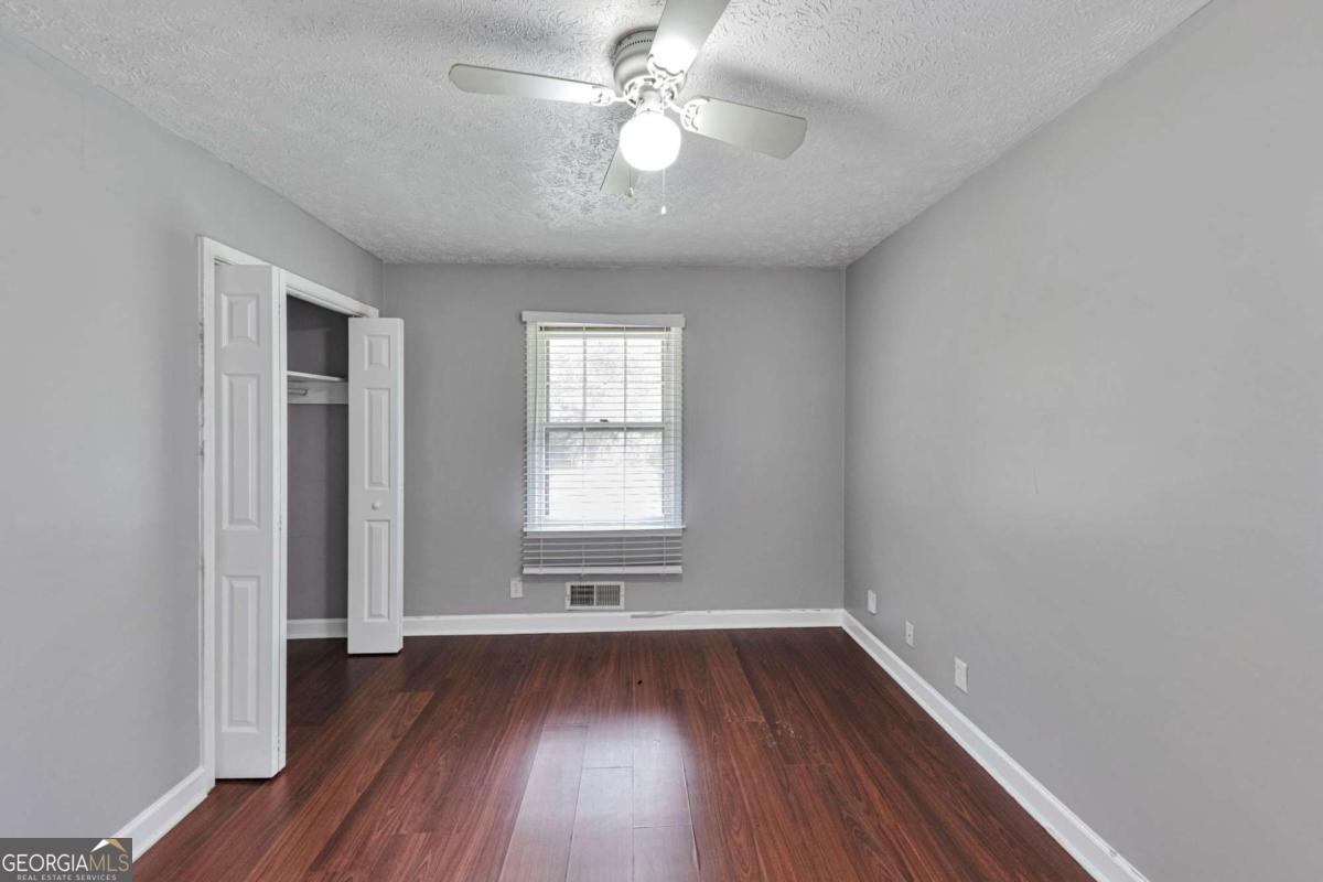 115 Elizabeth Way Ellenwood, GA 30294 - Photo 9 of 15 wooden floor in an empty room with a window