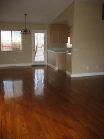 1930 Summer Star Road Reno, NV 89511 - Photo 2 of 9 an empty room with wooden floor and windows