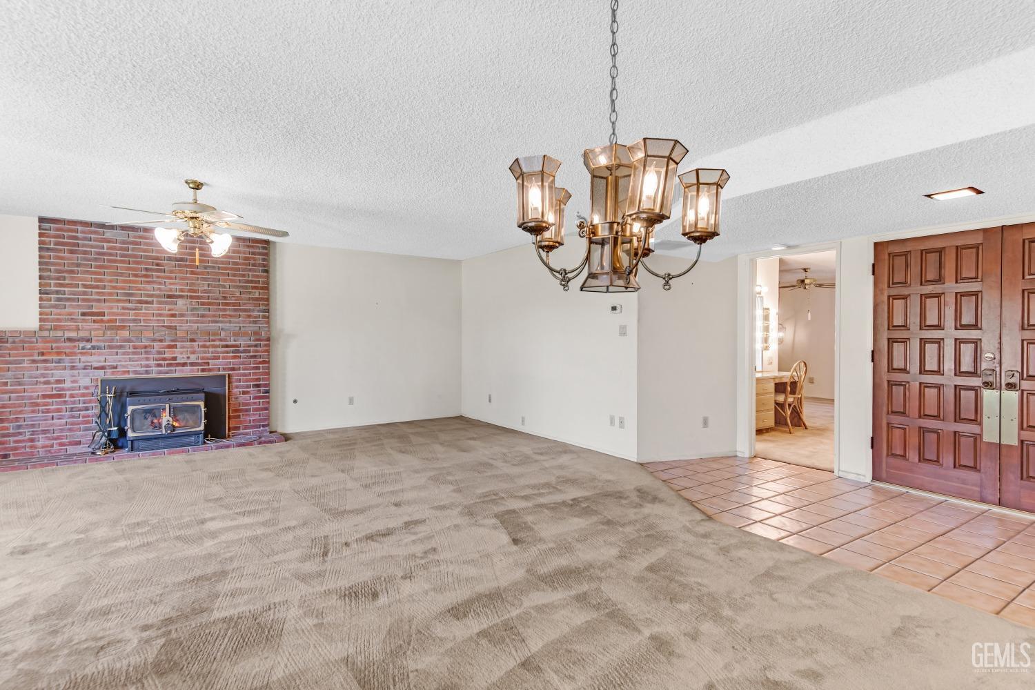 Undisclosed Address Bakersfield, CA 93309 - Photo 15 of 46 a view of a livingroom with a chandelier