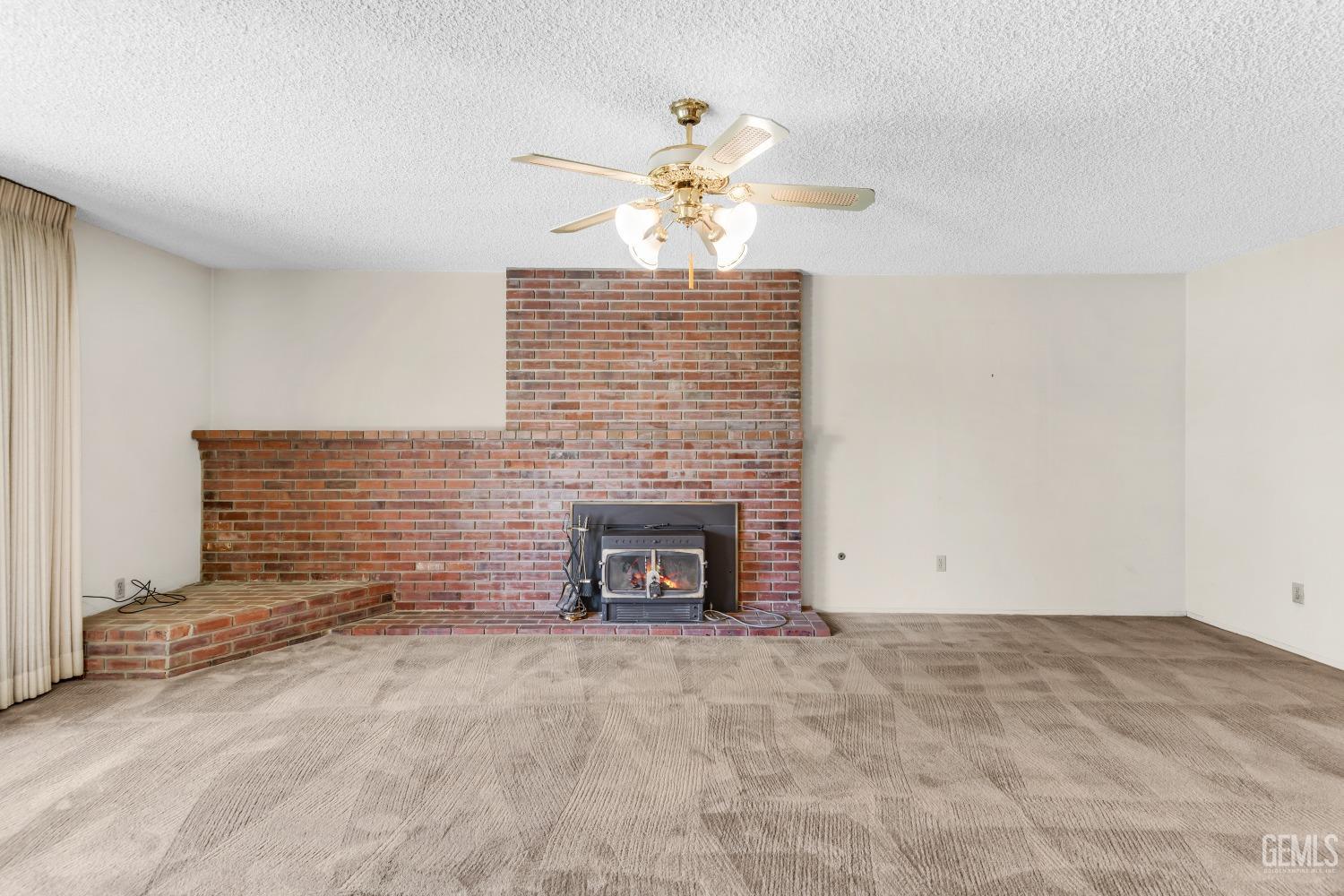 Undisclosed Address Bakersfield, CA 93309 - Photo 16 of 46 a view of an empty room with a fireplace
