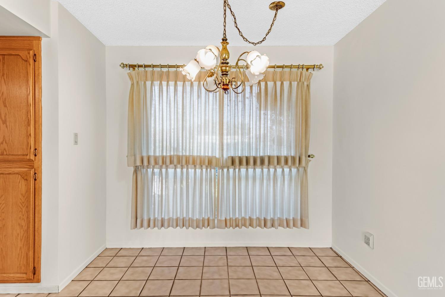 Undisclosed Address Bakersfield, CA 93309 - Photo 25 of 46 a view of an empty room with chandelier and a window