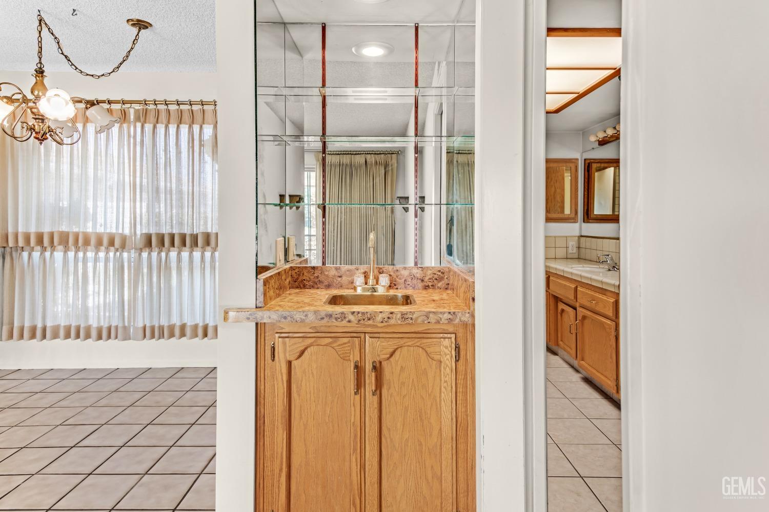 Undisclosed Address Bakersfield, CA 93309 - Photo 27 of 46 a bathroom with a granite countertop sink and a mirror