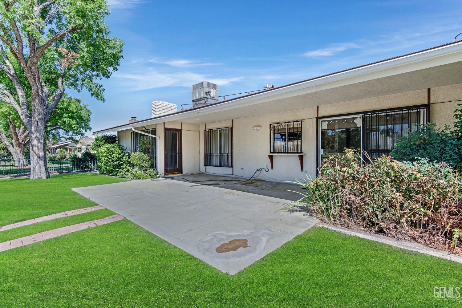Undisclosed Address Bakersfield, CA 93309 - Photo 34 of 46 a view of a house with a yard and potted plants