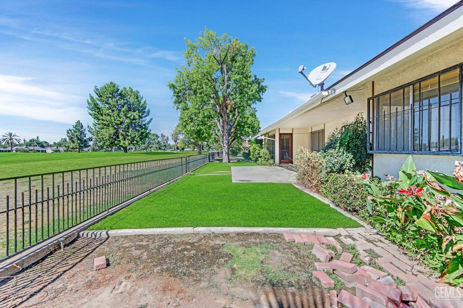 Undisclosed Address Bakersfield, CA 93309 - Photo 36 of 46 a view of a backyard with potted plants and floor to ceiling window