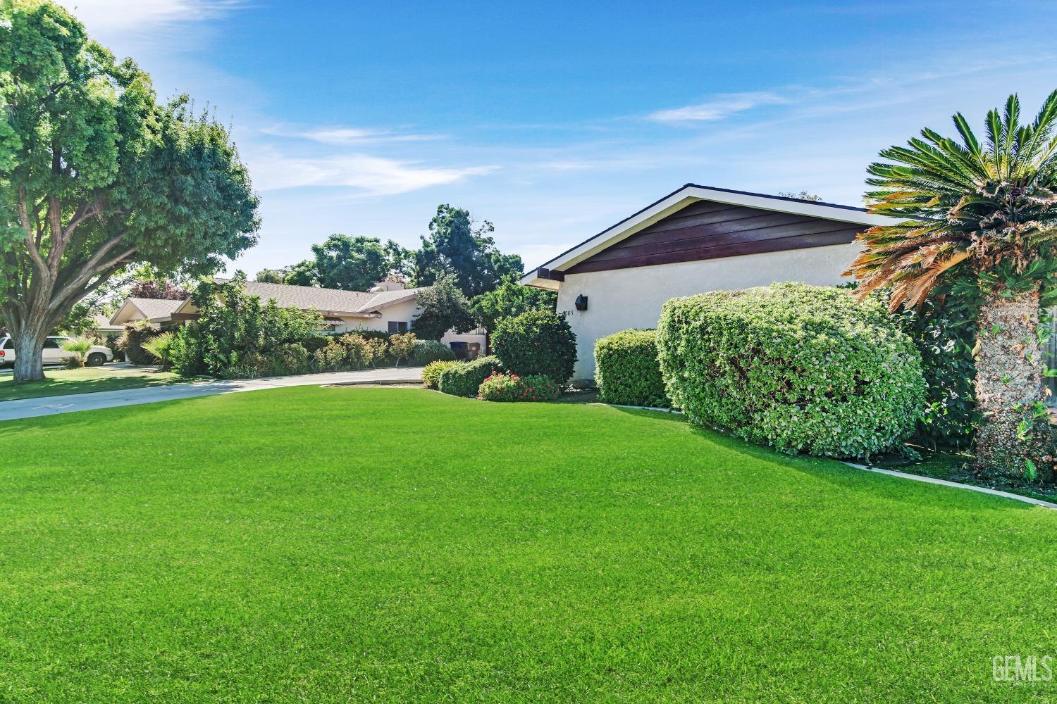 Undisclosed Address Bakersfield, CA 93309 - Photo 45 of 46 a front view of a house with a yard and potted plants