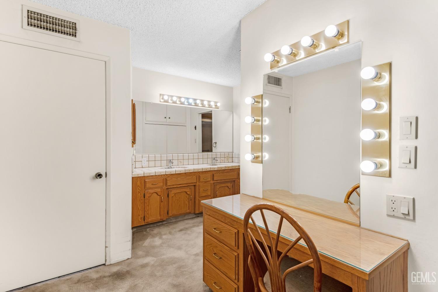 Undisclosed Address Bakersfield, CA 93309 - Photo 9 of 46 a spacious bathroom with a granite countertop sink a mirror a bathtub and a shower